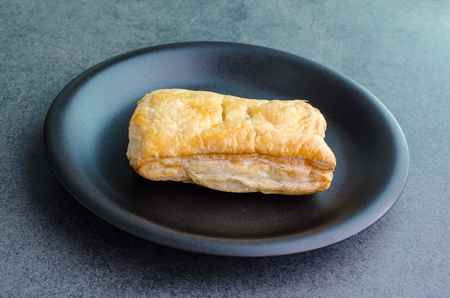 Rectangular baked bread on plate on stone backgroundの写真素材