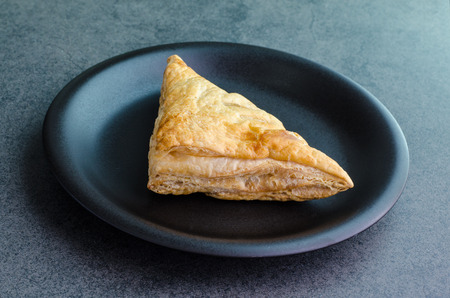 Triangle baked bread on plate on stone backgroundの写真素材