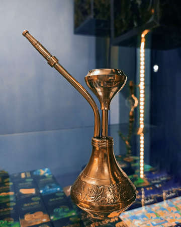 shiny copper hookah on a glass tableの写真素材