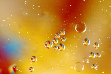 Beautiful colorful bubbles of oil in water captured on a macro scaleの写真素材