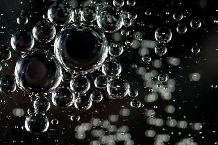 Beautiful colorful bubbles of oil in water captured on a macro scaleの写真素材
