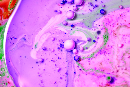 abstract background with purple and green oil paint, close-up