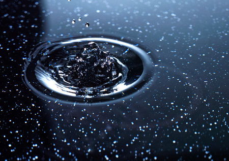 Falling drops of water. Splash effect after collision and falling drops with water Surfaceの写真素材