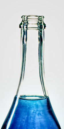 Close-up of a bottle of blue water on a white background