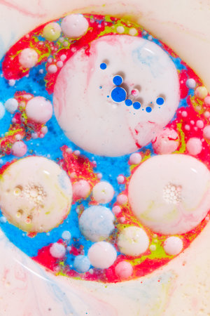 Colorful abstract background of acrylic paint in water with bubbles and dots