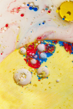 Abstract background of watercolor with colorful spots and stains on a yellow backgroundの写真素材