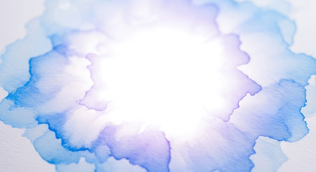 Soft blue and purple watercolor paint stains spread across white textured paper with bright light in...