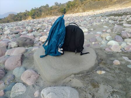 Blue and Black Travel Bag On Stone Indiaの写真素材