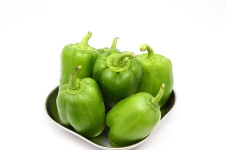 fresh green bell peppers (capsicum) on a white backgroundの写真素材