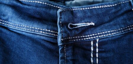 Old Blue jeans fashion design On brown hemp sack texture background,.Ripped jeans of a stack Hipster...