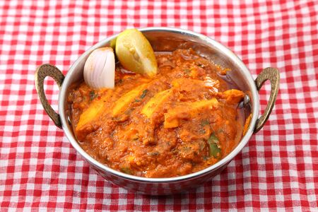 Indian Food or Indian Curry in a copper brass serving bowl.の写真素材
