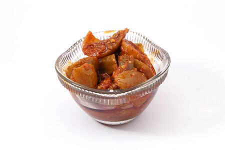 Indian style pickle in a glass bowl on white backgroundの写真素材