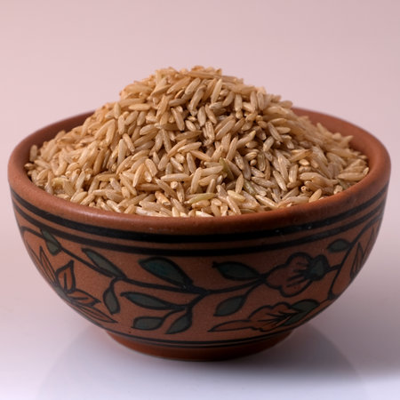 Raw brown rice in a bowlの写真素材