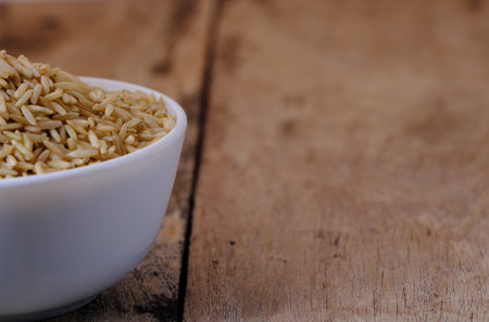 Raw brown rice in a bowlの写真素材
