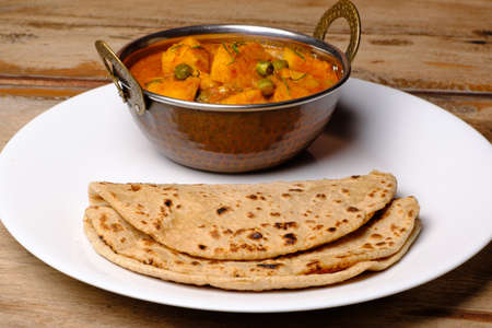 Indian style cottage cheese dish or curry with rotiの写真素材