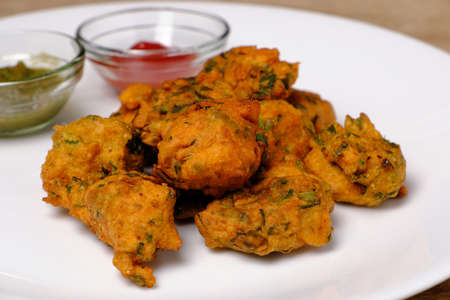 Indian snack pakora with tomato sauce or chutneyの写真素材