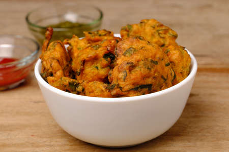 Indian snack pakora with tomato sauce or chutneyの写真素材