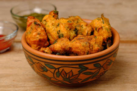 Indian snack pakora with tomato sauce or chutneyの写真素材