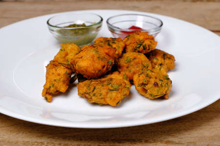 Indian snack pakora with tomato sauce or chutneyの写真素材