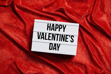 happy valentines day - text on lightbox or light box sign on red velvet backgroundの素材