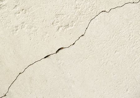 Crack crossing a concrete plate for a backgroundの写真素材