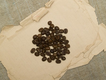 coffee beans scattered on the old paperの写真素材