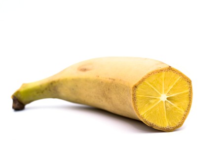 abstract image of a genetically modified banana, hybridized with an orange on a white background
