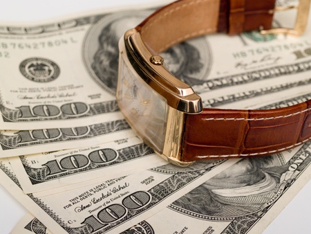 gold watches are on dollar billsの写真素材