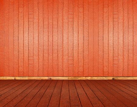 Fragment of a room with wooden floors and a wall of redの写真素材