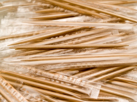a large group of wooden toothpicks wrapped in transparent filmの写真素材