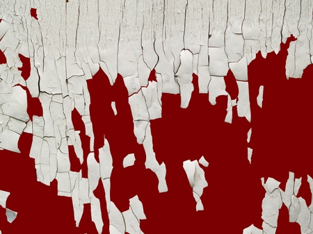 old cracked white paint on red backgroundの写真素材