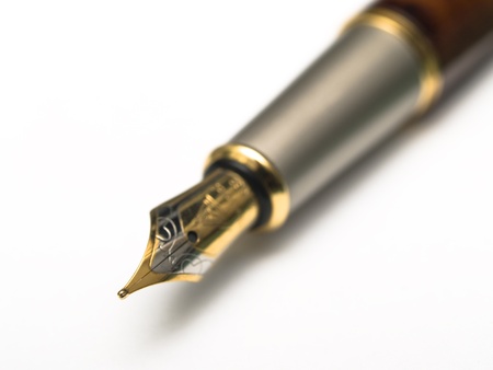 fountain pen against a sheet of white paperの写真素材