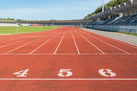 Red treadmill at the stadium with the numbering の写真素材