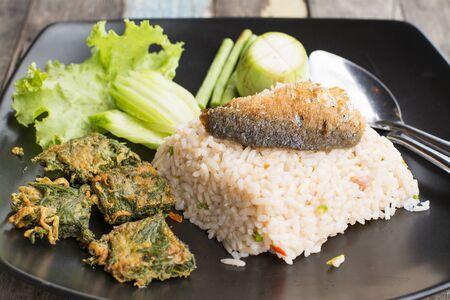 close up mixed cooked rice with fried fish and sauceの写真素材
