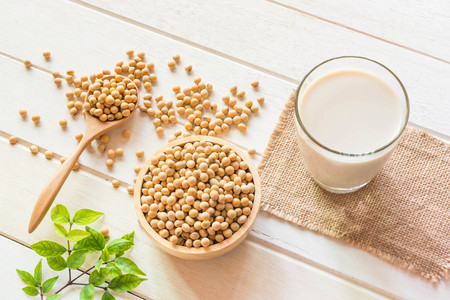 Soy milk in glass and soy been on spoon it on white table background,healthy concept.の写真素材