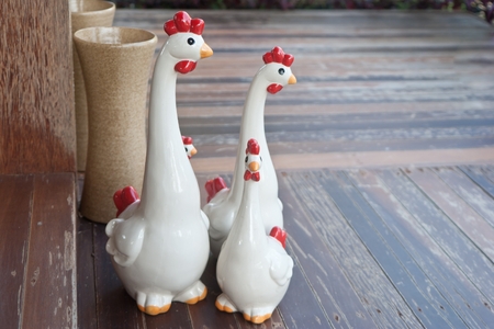 family chickens ceramic on pattern wood.の写真素材