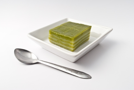 Thai sweetmeat or Khanom Chan is a kind of sweet Thai dessert, in white bowl on white backgroundの写真素材