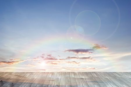 old wooden texture and rainbow with lens flare in blue sky backgroundの写真素材