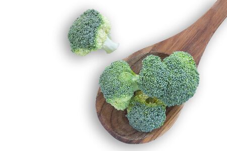 Fresh broccoli vegetable in wooden spoon isolated on white backgroundの写真素材