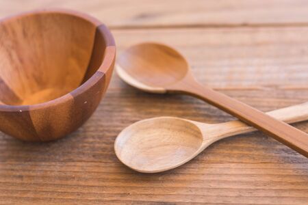 Empty wooden bowl and spoon on old wooden backgroundの写真素材