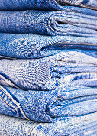 lot of denim blue jean texture is the classic indigo fashion. close-up of denim blue jeans, concept for fashionの写真素材