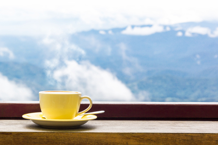 Coffee Mug On Wooden Top Table In Arial View Of Mountian.の写真素材