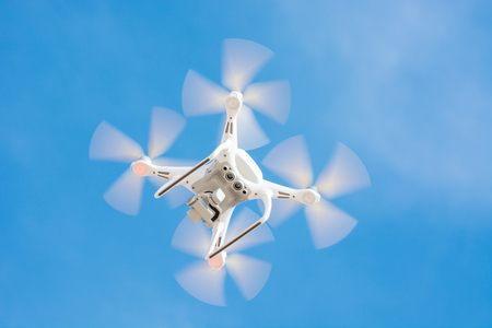 Drone Of White Color Flying In The Blue Sky, Concept Video Technology.のeditorial素材