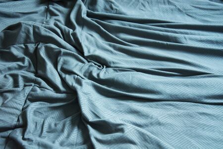 Top View Of Blue Blanket That Wrinkles On The Bed After Sleep In A Long Night.
