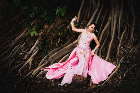 Asian Women Dressed In Lanna Thai Traditions, In Ancient Places And Refreshing Nature.の写真素材