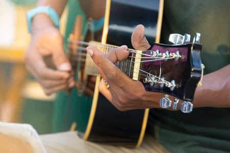 Closeup Of Man's Hand Playing Acoustic Guitar, Soft Vintage Style.