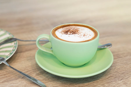 Green Cup Of Coffee Latte On Wooden Background, Close Up Of Art Coffee In Morning.の写真素材