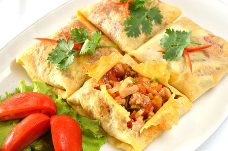 A delicious omelet with ham and tomatoの写真素材