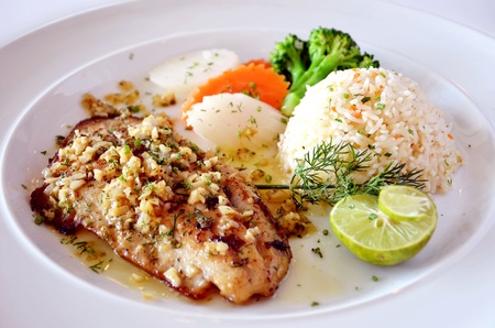 roasted fish served with fried rice の写真素材