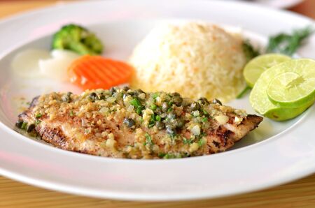 roasted fish served with fried riceの写真素材